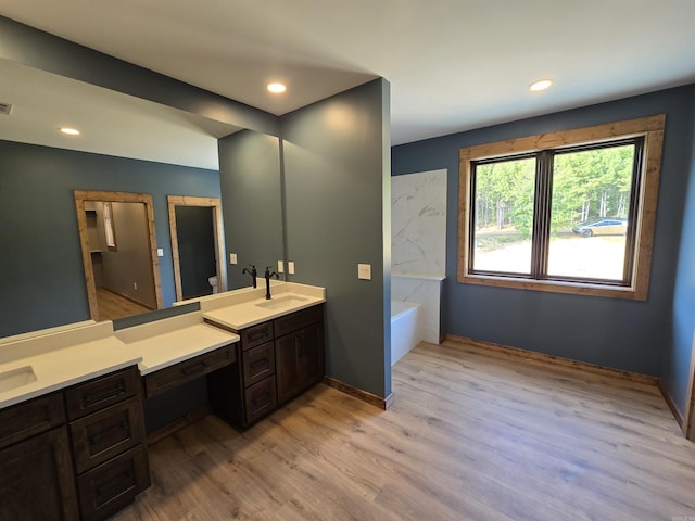 bathroom featuring a bathtub, toilet, vanity, and hardwood / wood-style flooring