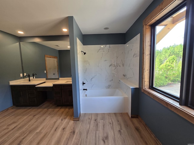 bathroom with independent shower and bath, hardwood / wood-style floors, and vanity