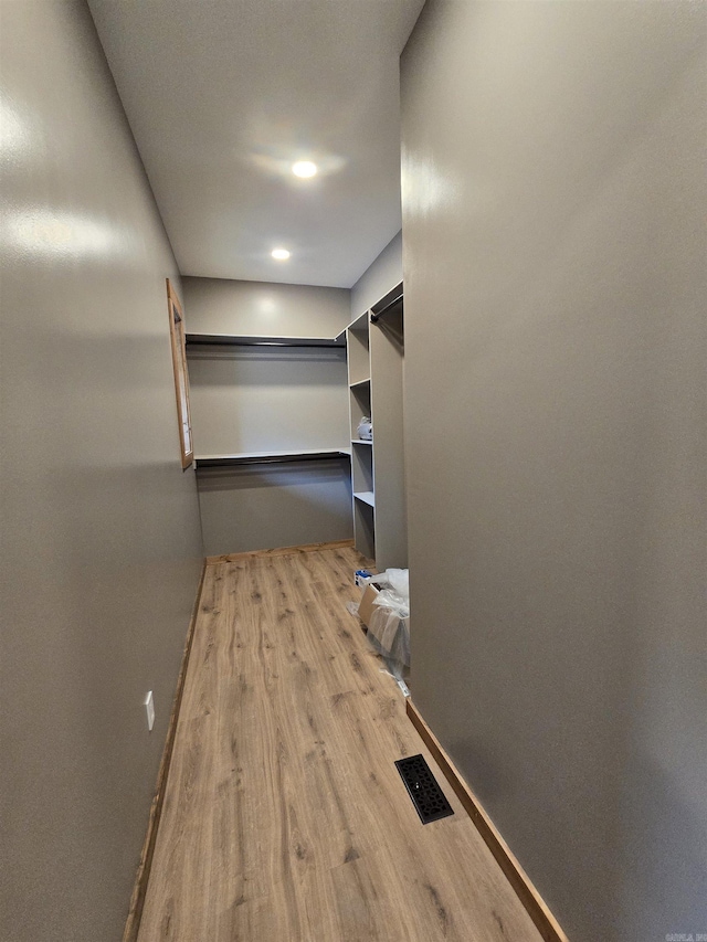 walk in closet featuring light hardwood / wood-style floors