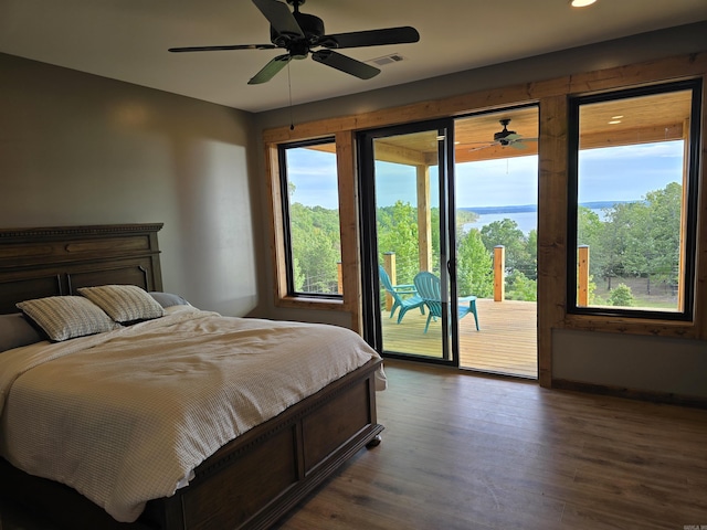 bedroom featuring ceiling fan, dark wood-type flooring, and access to exterior