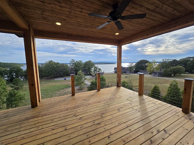 wooden deck with ceiling fan and a water view