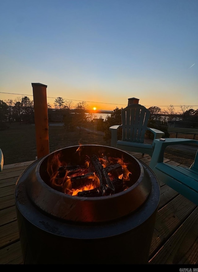 pool at dusk with a fire pit