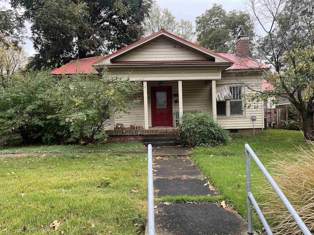 bungalow-style home with a front lawn