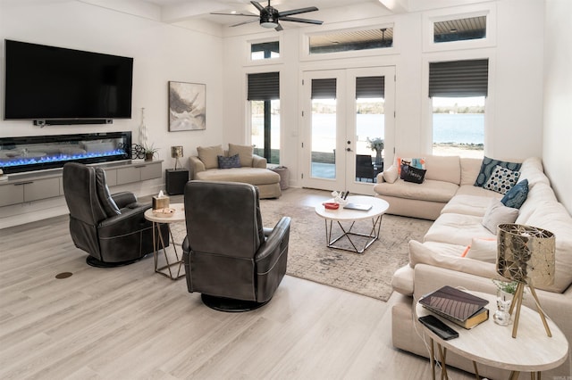 living room featuring french doors, ceiling fan, beamed ceiling, and light hardwood / wood-style flooring