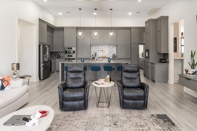 living room featuring light hardwood / wood-style flooring and sink