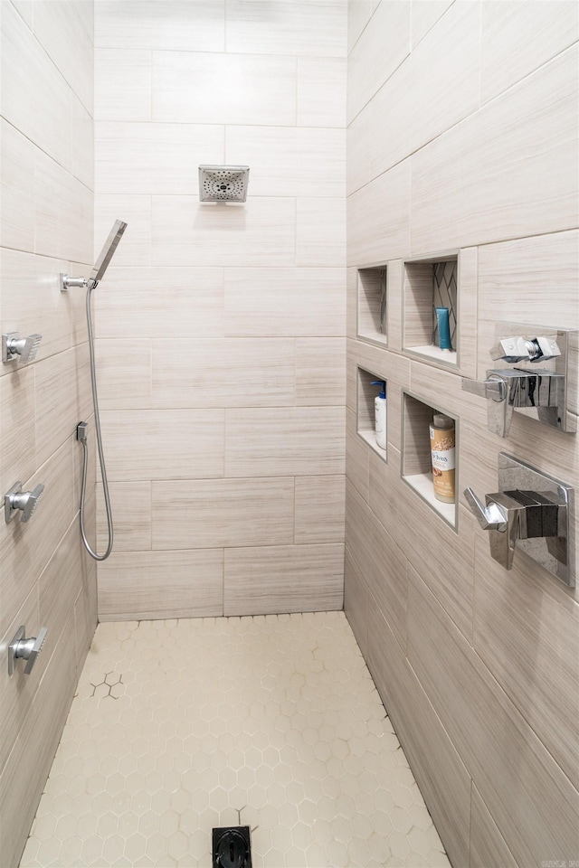 bathroom with tiled shower