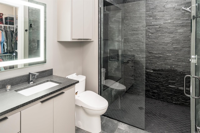 bathroom featuring toilet, vanity, tile patterned floors, and walk in shower