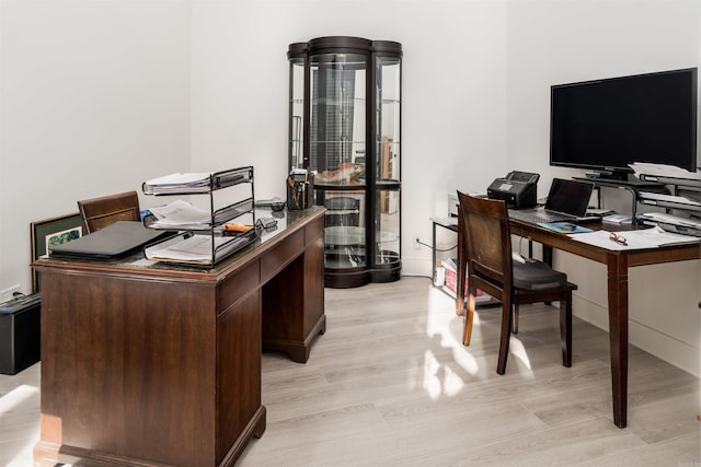 office area with light hardwood / wood-style floors