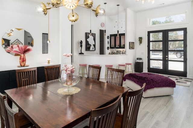 dining area featuring light hardwood / wood-style floors and french doors