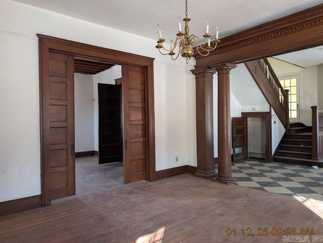 unfurnished dining area with ornate columns and an inviting chandelier