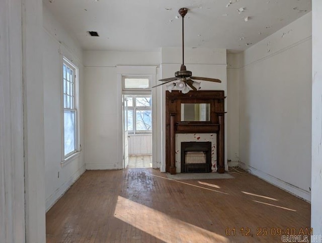 unfurnished living room with ceiling fan and hardwood / wood-style flooring