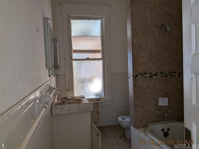 bathroom featuring vanity, tile walls, and a wealth of natural light