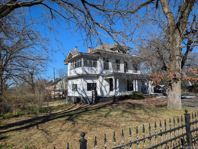 italianate home with a porch and a front yard