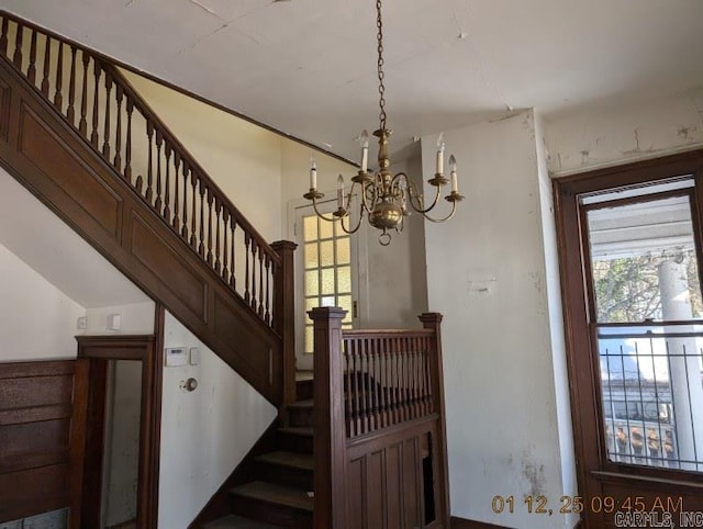 stairway with an inviting chandelier