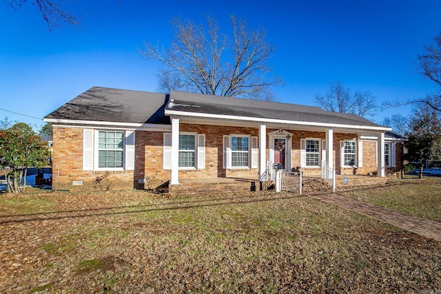 ranch-style home featuring a porch and a front yard