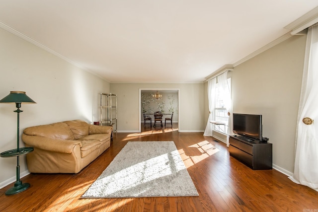 living room featuring ornamental molding, a chandelier, and wood-type flooring