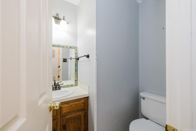 bathroom with toilet and vanity