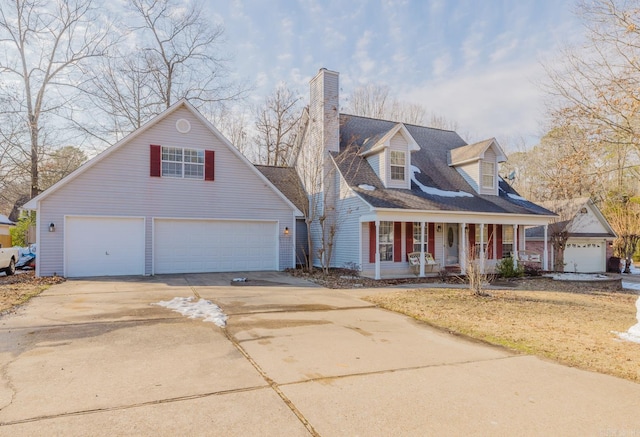 new england style home featuring a garage and covered porch