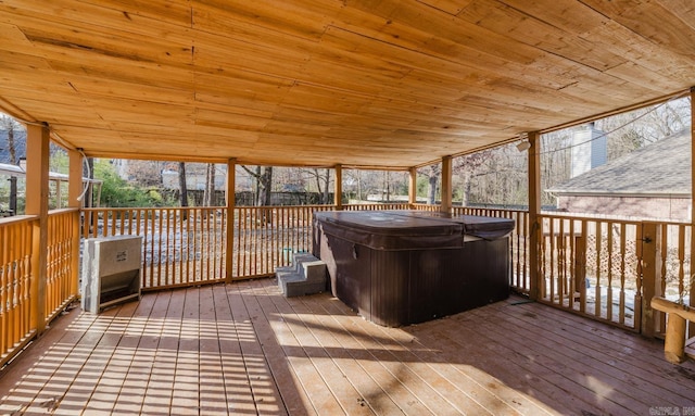 wooden deck with a hot tub