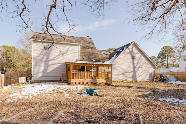 back of house with ac unit and a deck