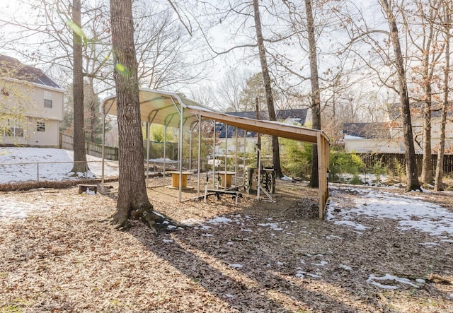 yard layered in snow featuring a playground