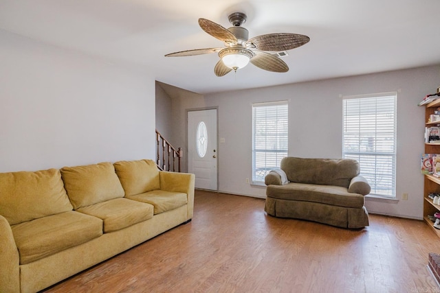 living room featuring ceiling fan, hardwood / wood-style floors, and plenty of natural light