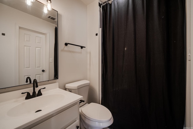 bathroom with toilet and vanity