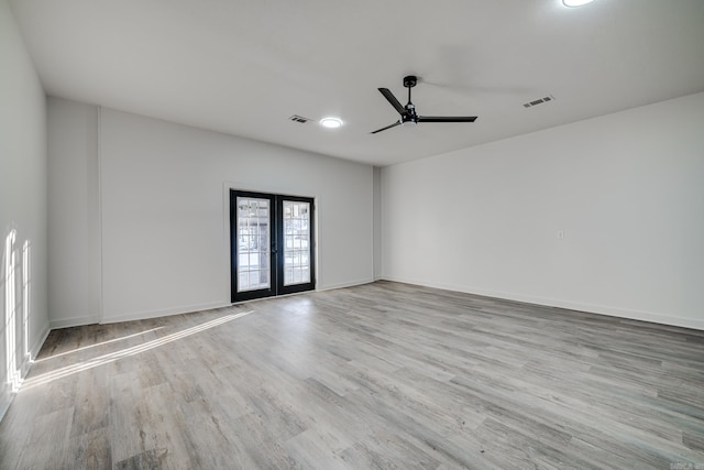 unfurnished room with ceiling fan, french doors, and light hardwood / wood-style floors