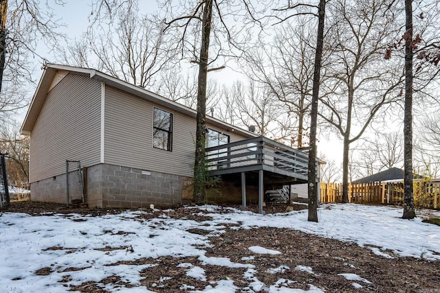 view of snow covered exterior with a deck