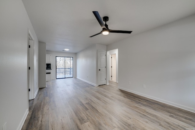 spare room with light hardwood / wood-style floors and ceiling fan