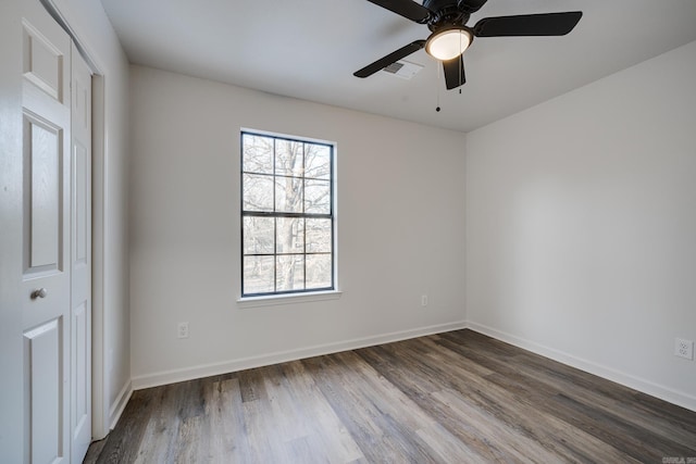 empty room with ceiling fan and hardwood / wood-style floors