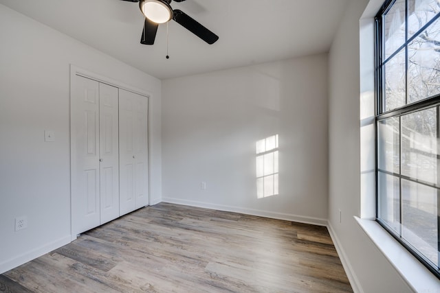 unfurnished bedroom with a closet, ceiling fan, and light hardwood / wood-style floors