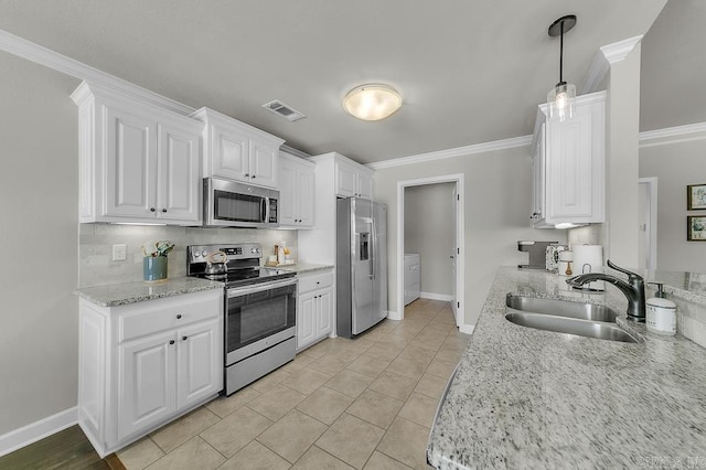 kitchen with stainless steel appliances, sink, white cabinets, light tile patterned flooring, and pendant lighting