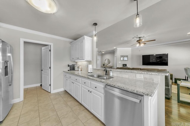 kitchen featuring kitchen peninsula, decorative light fixtures, stainless steel appliances, white cabinets, and sink