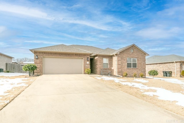 ranch-style house featuring central AC unit and a garage