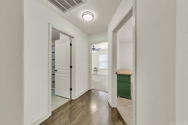 hallway with dark hardwood / wood-style floors