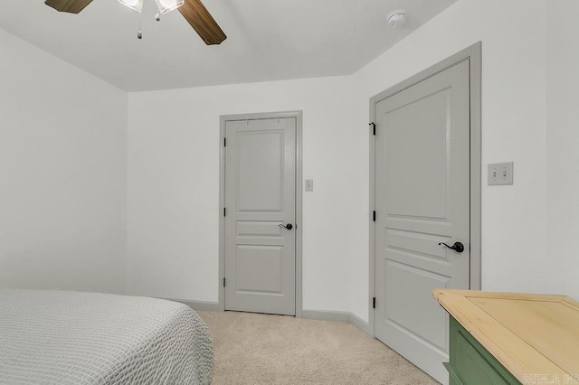 bedroom featuring ceiling fan and light carpet