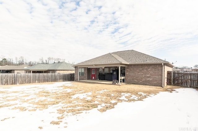 snow covered property featuring a patio area