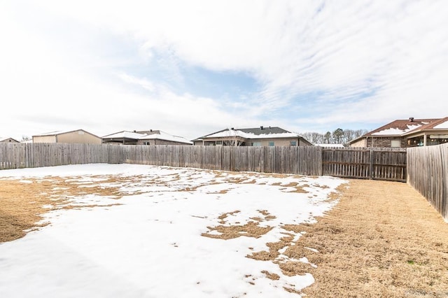 view of yard layered in snow