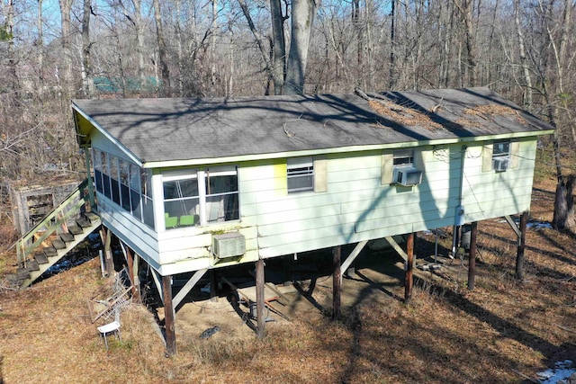 back of property with a sunroom