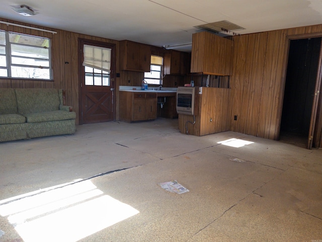 kitchen with heating unit and wood walls