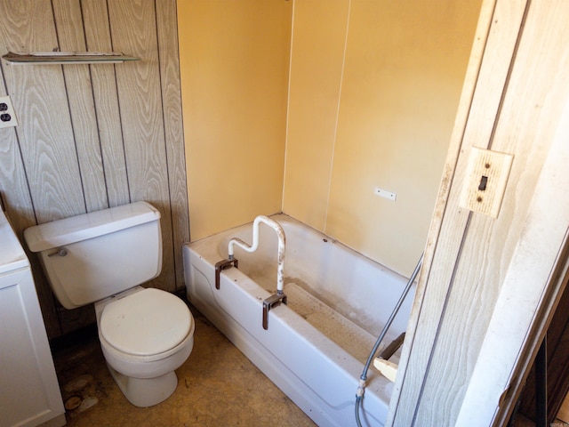 bathroom featuring toilet and a tub