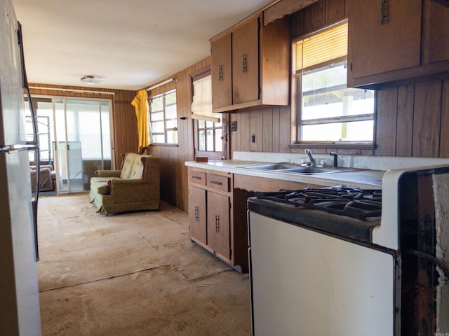 kitchen with sink and wood walls