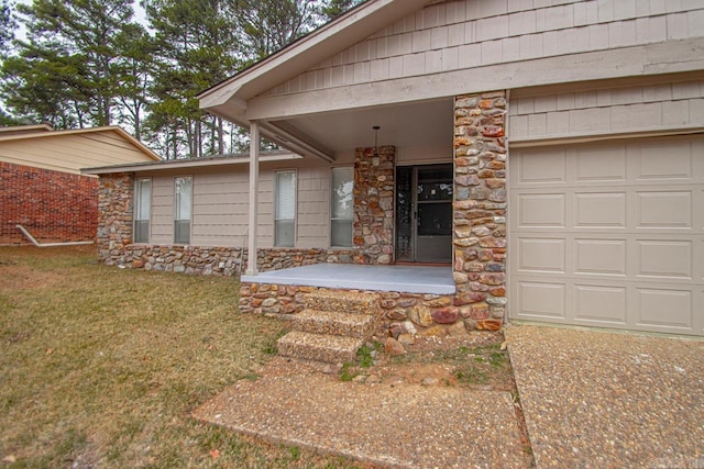 property entrance with a yard and a garage