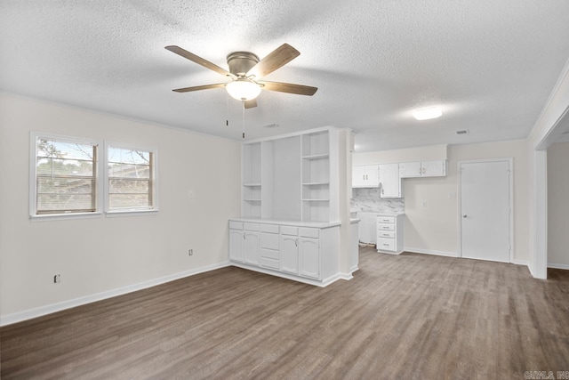 unfurnished living room with a textured ceiling, ceiling fan, and hardwood / wood-style floors