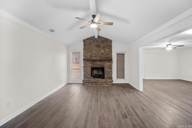 unfurnished living room with dark hardwood / wood-style floors, ceiling fan, vaulted ceiling, and a stone fireplace