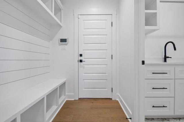 mudroom with light hardwood / wood-style floors and sink