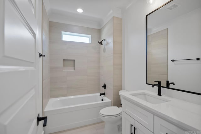 full bathroom with vanity, tiled shower / bath combo, and toilet