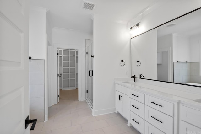 bathroom with tile patterned flooring, ornamental molding, walk in shower, and vanity