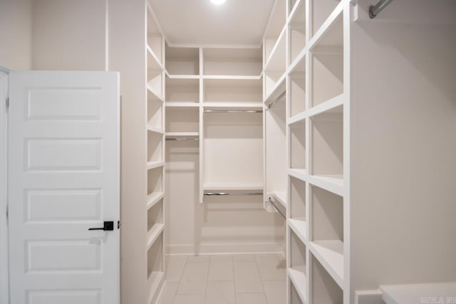 spacious closet with light tile patterned floors